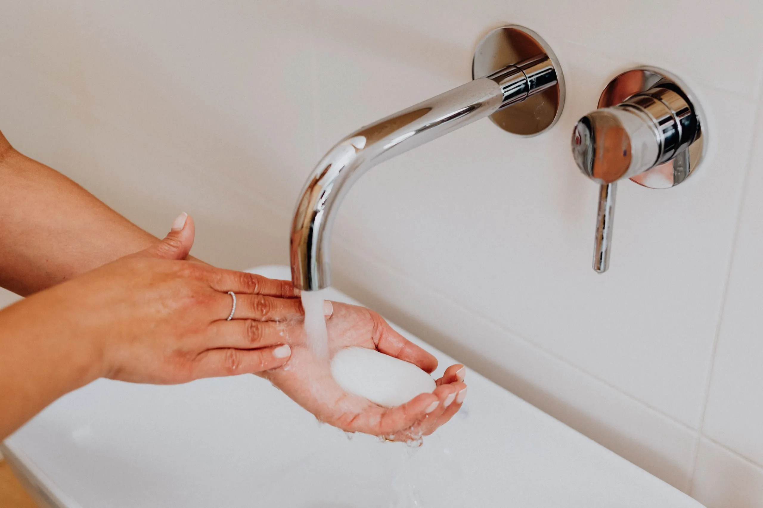 Hands washed with soap under a tap